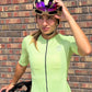female cyclist in a lime green jersey